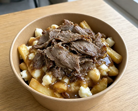 Beef gyro poutine with fries, cheese curds and gravy in a kraft bowl